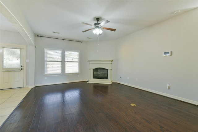 unfurnished living room featuring hardwood / wood-style floors and ceiling fan