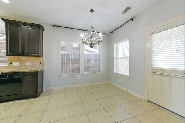 unfurnished dining area featuring light tile patterned flooring and an inviting chandelier