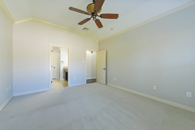 unfurnished bedroom featuring ensuite bathroom, light colored carpet, lofted ceiling, and ceiling fan