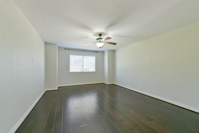 unfurnished room with a textured ceiling, dark hardwood / wood-style flooring, and ceiling fan