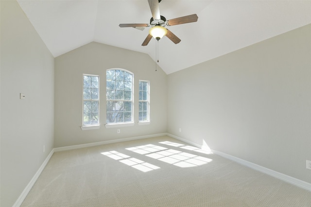 unfurnished room with vaulted ceiling, light carpet, and ceiling fan