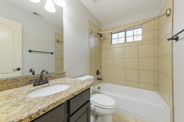 full bathroom with vanity, toilet, and tiled shower / bath