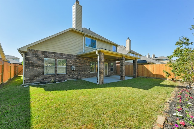 back of property featuring a yard and a patio area