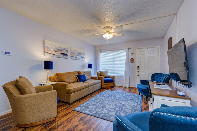 living room with ceiling fan, a textured ceiling, and dark hardwood / wood-style flooring