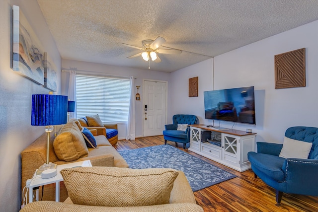 living room featuring hardwood / wood-style floors, a textured ceiling, and ceiling fan