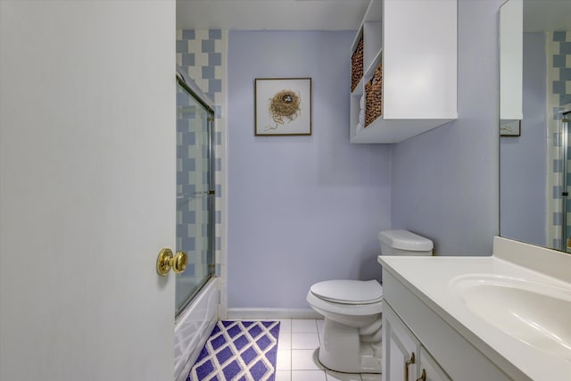 full bathroom featuring tile patterned flooring, vanity, toilet, and bath / shower combo with glass door