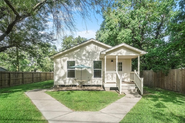 bungalow-style house with a porch and a front lawn