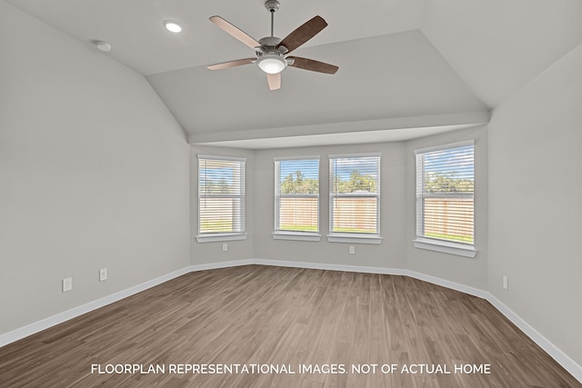 unfurnished room featuring hardwood / wood-style flooring, ceiling fan, and vaulted ceiling