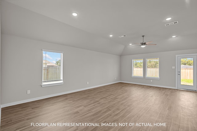 unfurnished room featuring hardwood / wood-style floors, ceiling fan, and vaulted ceiling