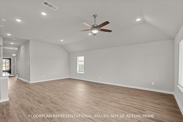 unfurnished living room featuring light hardwood / wood-style floors, ceiling fan, and lofted ceiling