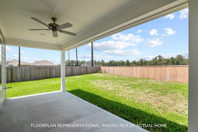 view of yard with ceiling fan and a patio