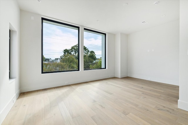 spare room with light hardwood / wood-style floors