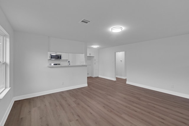 unfurnished living room featuring hardwood / wood-style floors