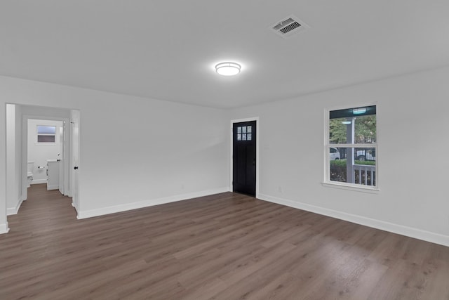 spare room featuring dark wood-type flooring