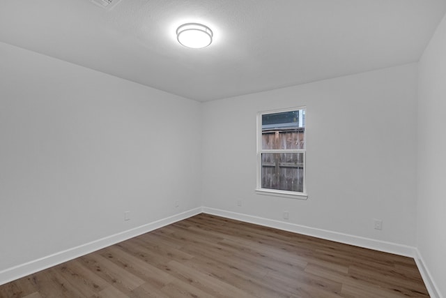 unfurnished room with hardwood / wood-style floors