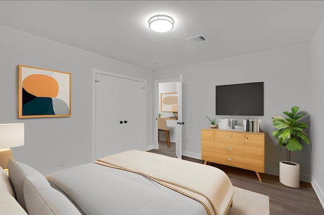 bedroom with dark wood-type flooring and a closet