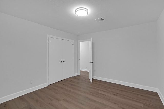 unfurnished room featuring hardwood / wood-style flooring