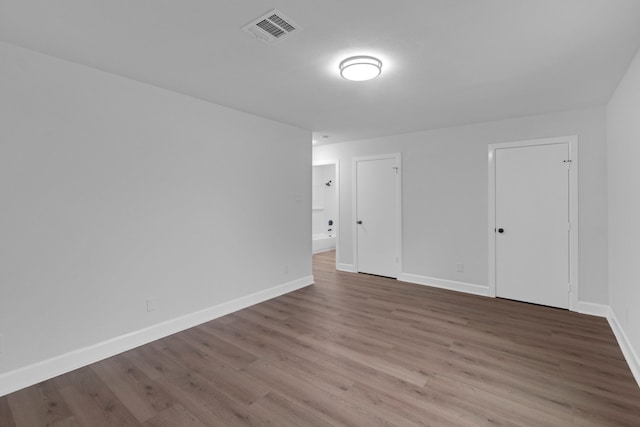 unfurnished room featuring hardwood / wood-style flooring