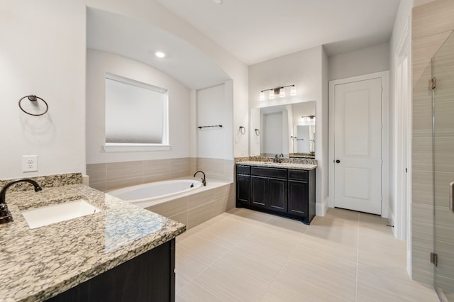 bathroom featuring tile patterned flooring, vanity, and independent shower and bath