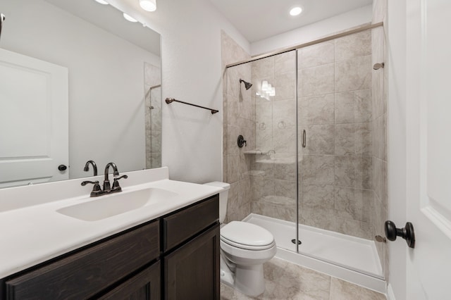 bathroom with toilet, vanity, and walk in shower