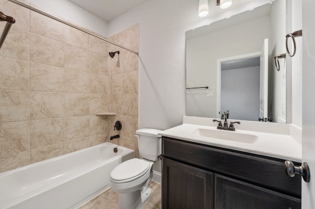 full bathroom with vanity, tiled shower / bath combo, and toilet