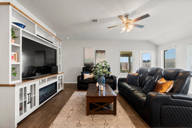 living room featuring ceiling fan, dark hardwood / wood-style floors, and lofted ceiling