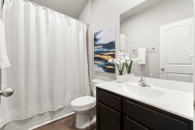 full bathroom featuring shower / bath combo with shower curtain, wood-type flooring, vanity, and toilet