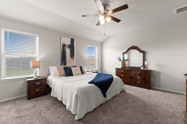 bedroom with ceiling fan, vaulted ceiling, and carpet floors