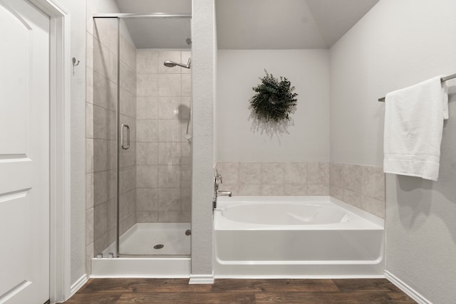 bathroom featuring hardwood / wood-style floors and shower with separate bathtub