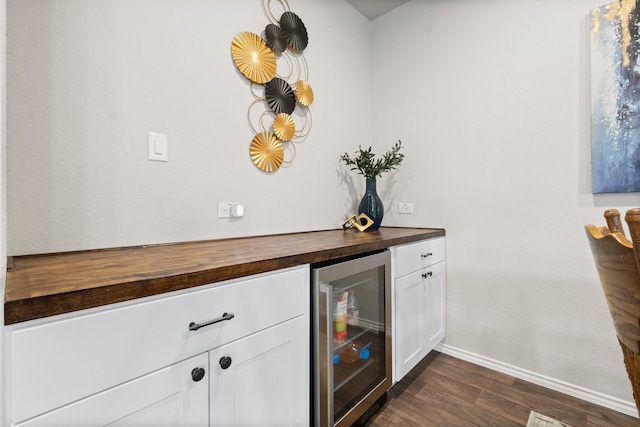 bar featuring white cabinets, wine cooler, butcher block countertops, and dark hardwood / wood-style flooring