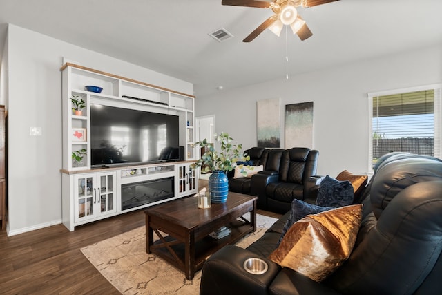 living room with ceiling fan and dark hardwood / wood-style floors