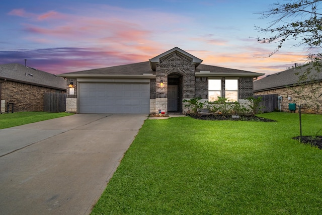 view of front of property with a garage and a lawn