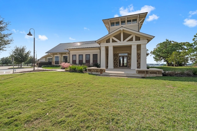 back of property featuring a lawn