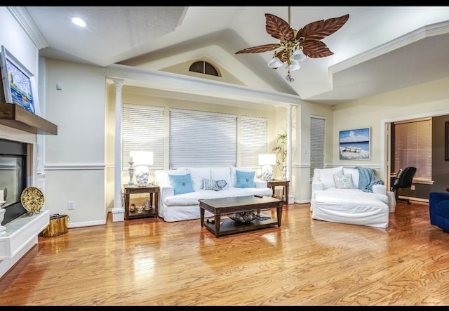 sitting room featuring high vaulted ceiling, light hardwood / wood-style flooring, ceiling fan, and decorative columns