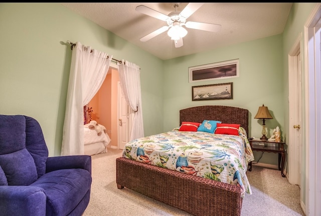 carpeted bedroom with ceiling fan and a textured ceiling