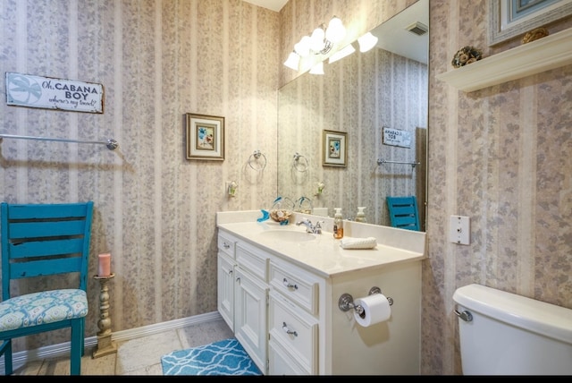 bathroom featuring toilet, vanity, and tile patterned floors