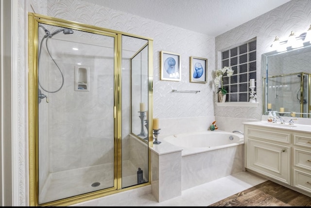 bathroom featuring vanity, a textured ceiling, shower with separate bathtub, and hardwood / wood-style floors