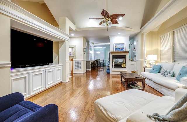 living room with ceiling fan, crown molding, light hardwood / wood-style flooring, and lofted ceiling