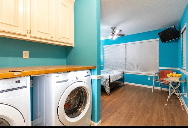 laundry area with hardwood / wood-style flooring, cabinets, ceiling fan, and washer and dryer