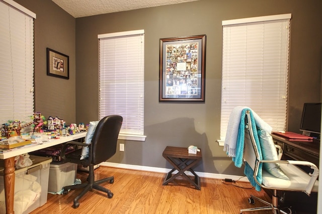 office featuring light hardwood / wood-style flooring and a textured ceiling