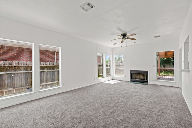 unfurnished living room featuring carpet and ceiling fan