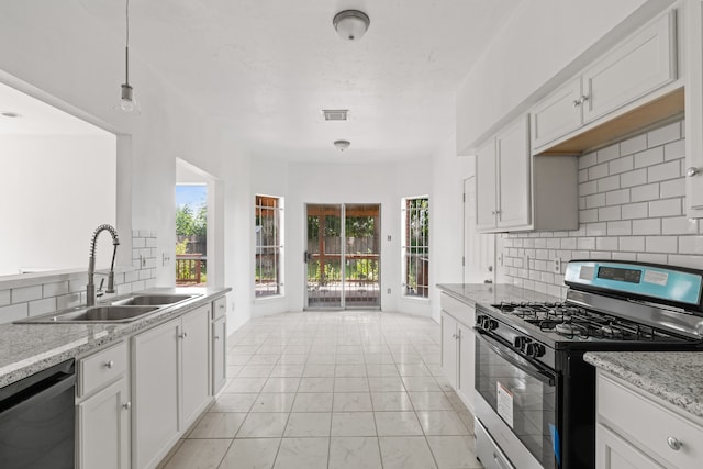 kitchen featuring stainless steel appliances, white cabinets, and decorative backsplash