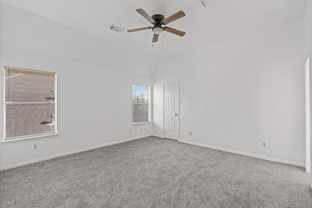 carpeted spare room with lofted ceiling and ceiling fan