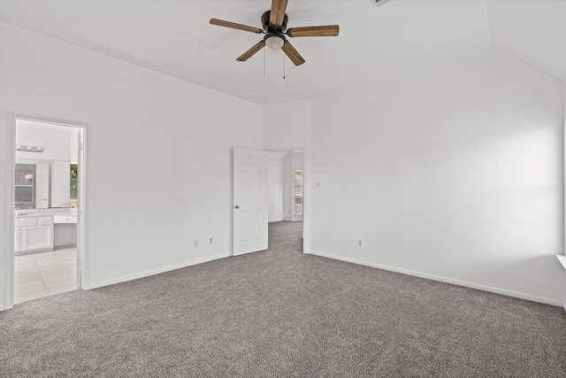 empty room with ceiling fan, light colored carpet, and lofted ceiling