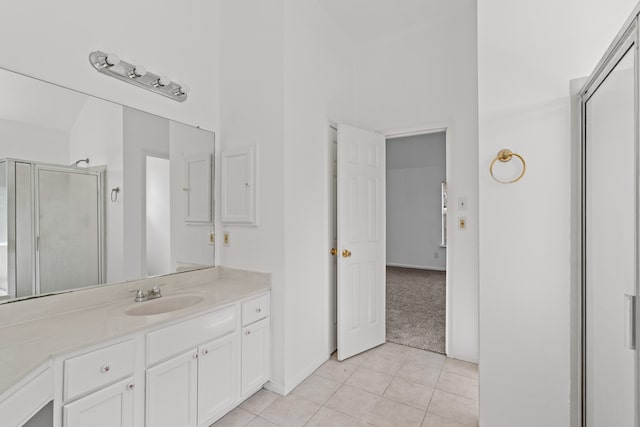 bathroom with vanity, a shower with door, and tile patterned flooring