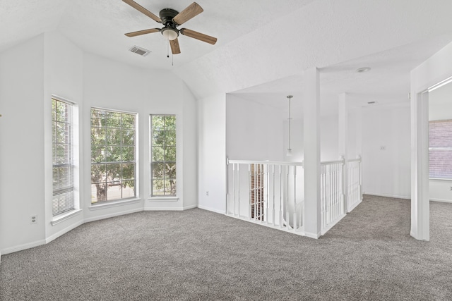 spare room with vaulted ceiling, ceiling fan, and carpet floors