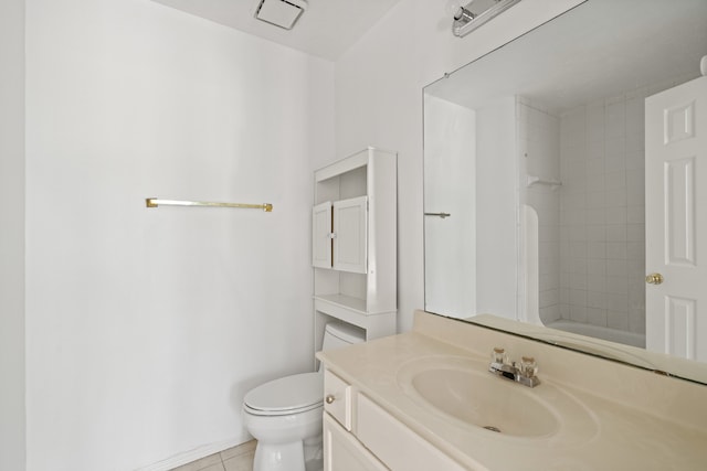 bathroom featuring vanity, tile patterned floors, and toilet