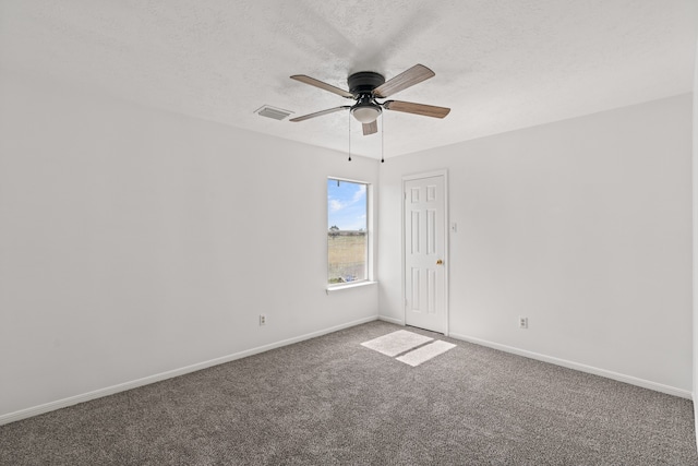 unfurnished room featuring ceiling fan, a textured ceiling, and carpet