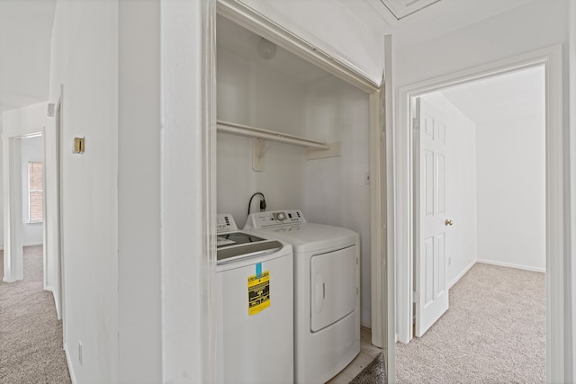 laundry room featuring separate washer and dryer and light colored carpet