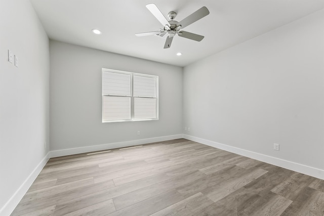 empty room featuring ceiling fan and light wood-type flooring